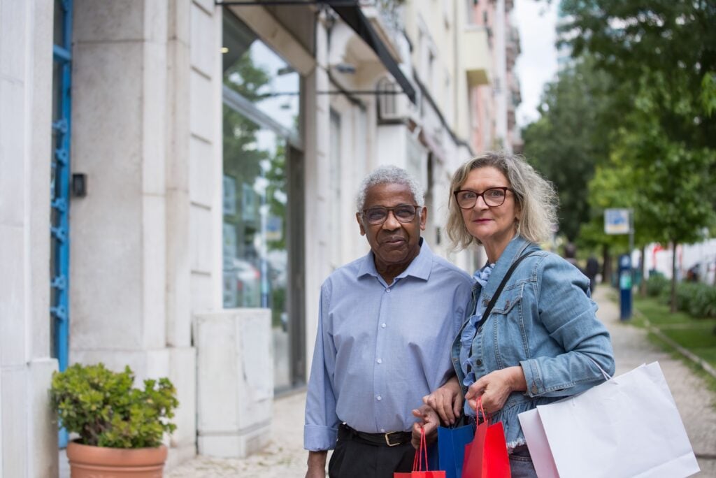 Companion caregiver helping two seniors stay socially connected while enjoying a shopping trip in Texas.